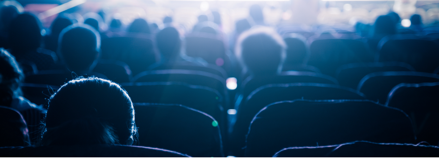 the outline of people sitting in a movie theatre